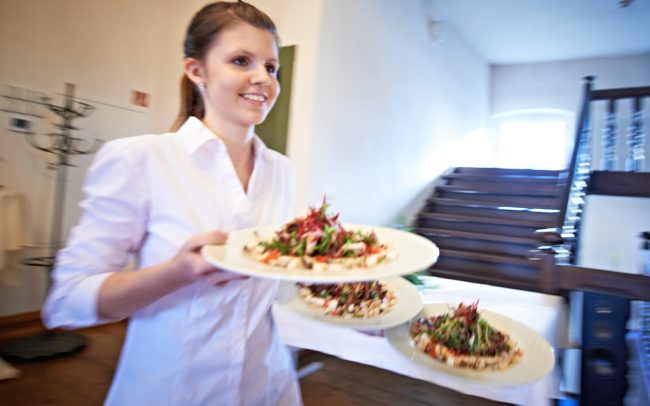Servicepersonal serviert Gerichte